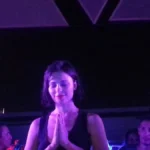 Nina Kraviz with hands pressed together at the end of a set