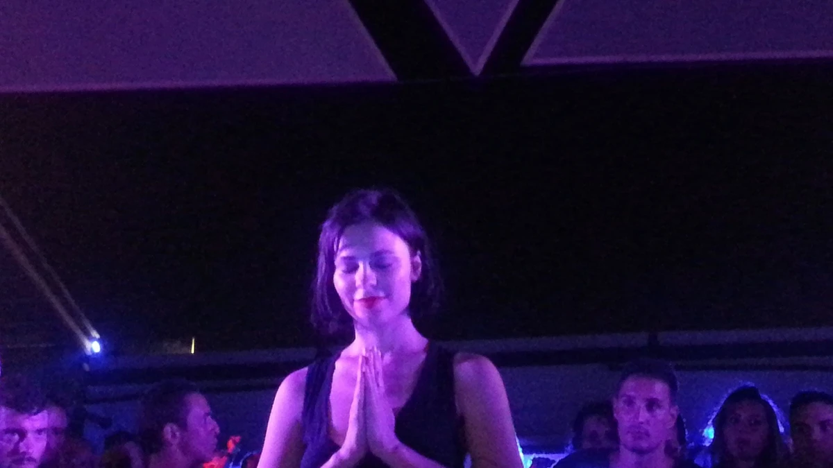 Nina Kraviz with hands pressed together at the end of a set