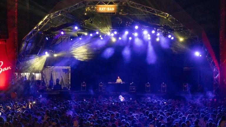 Peggy Gou performing to a large crowd on a festival stage