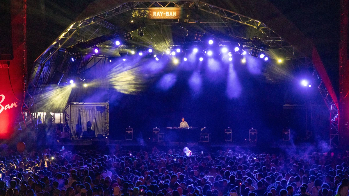 Peggy Gou performing to a large crowd on a festival stage