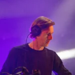 Richie Hawtin performing a DJ set with headphones