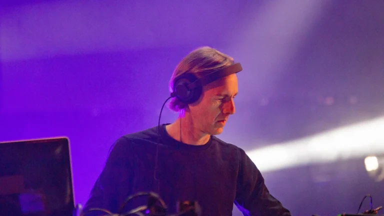 Richie Hawtin performing a DJ set with headphones