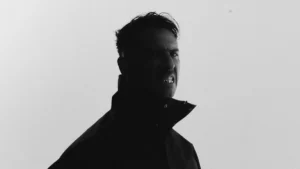 Boys Noize, Alex Ridha, in a black and white portrait against a pale background